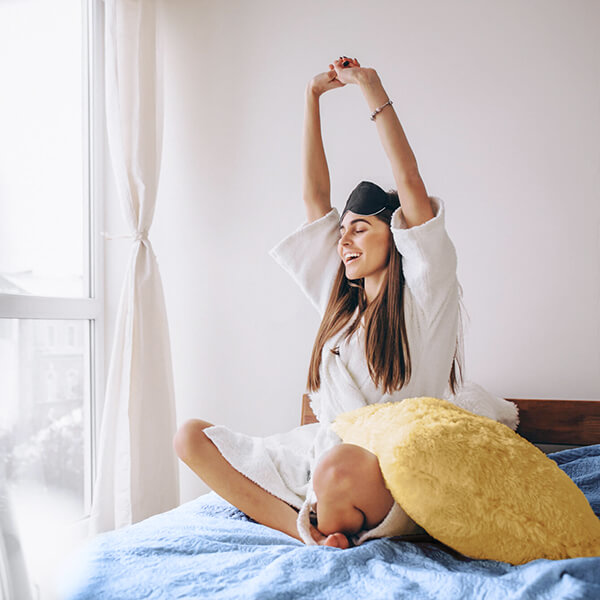 Woman stretching after a good nights sleep